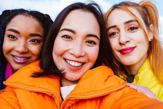 Multiracial group of young friends meeting outdoors in winter
