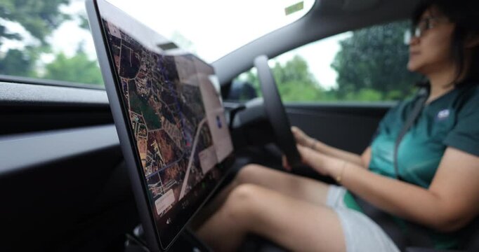 Casual woman drive ev car navigator on screen transport technology