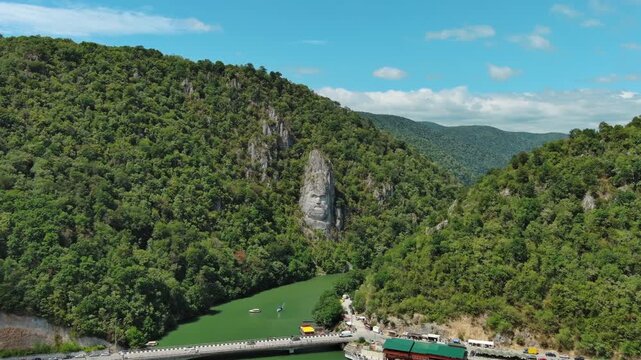 Aerial view of stone carved statue portrait of ancient dacian king Decebal. Sculpture located on shore of Danube River, Romania, 4k