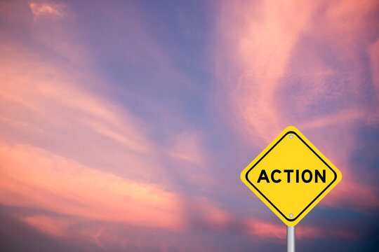 Yellow transportation sign with word action on violet color sky background