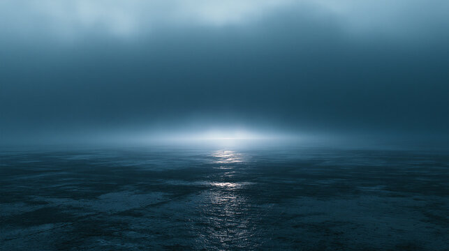 A serene dark ocean surface under heavy fog and low light reflecting a faint glow. Moody concept for mystery, loneliness, or peaceful reflection.