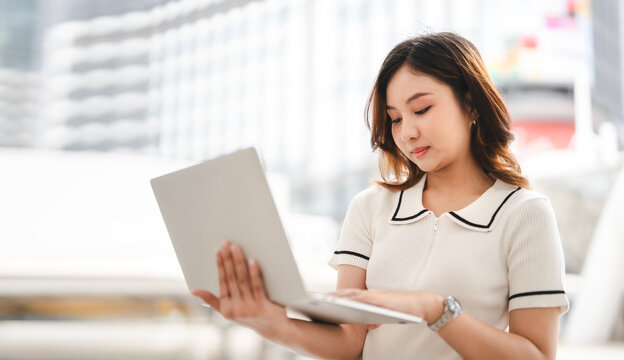 Asian business woman using laptop device remote work with fast wireless internet and ai modern technology