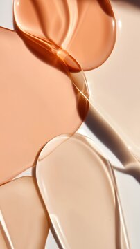 Glossy skincare liquid drops in soft orange-beige tones evoke a sense of radiance and moisture. Minimal and clean, this abstract composition highlights hydration and nourishment.