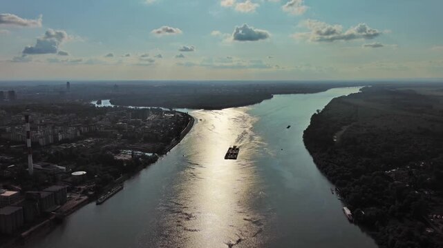 Aerial view of Belgrade at confluence of Sava and Danube rivers. Urban landscape, forested river island and city view, 4k