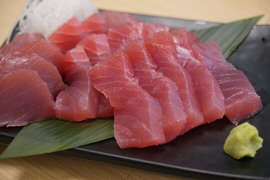 Fresh raw tuna sashimi served with wasabi and radish.