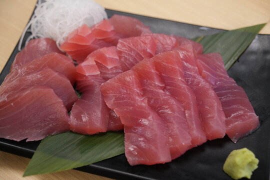 Fresh raw tuna sashimi served with wasabi and radish.