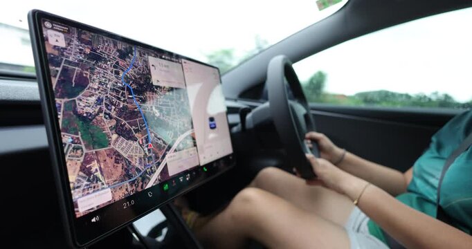 Casual woman drive ev car navigator on screen transport technology