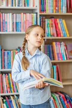 Kid reading book in library