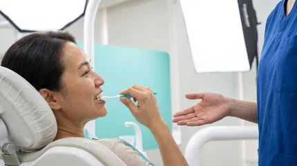 Adult patient practices gumline brushing in care bay © tilialucida