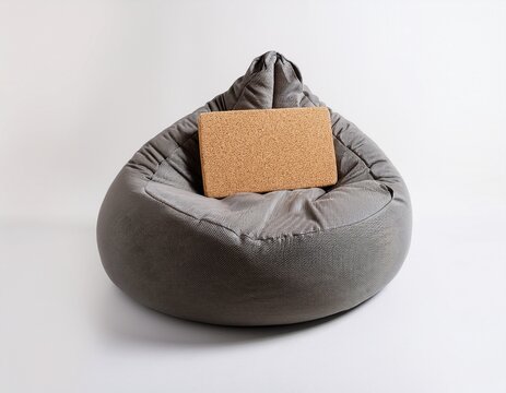 gray fabric bean bag chair with rectangular cork yoga block white background