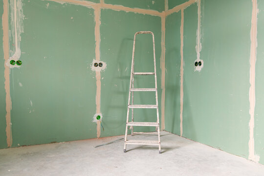 Empty unfinished interior with renovation equipment and copy space
