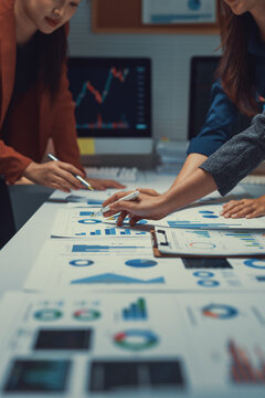 Businesspeople analyzing financial data charts in office
