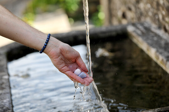 Cleansing healing stones under running water