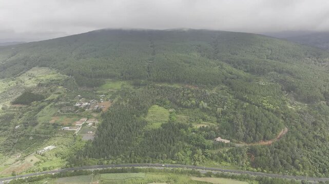 Aerial drone view of the Lien Khuong&ndash;Da Lat Expressway winding through the green mountain landscape around Nui Voi, Hiep Thanh Commune, Lam Dong Province, Vietnam.