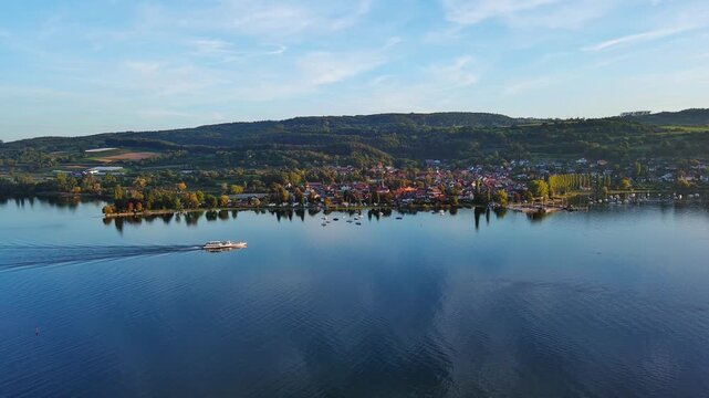 Aerial View of Serene Lake Town with Boat Cruising on Calm Water