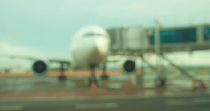 Blurred background of Boeing airliner parked at terminal gate during boarding at Airport