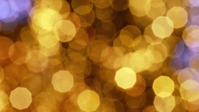 Golden bokeh lights gleaming in abstract soft blurred night background motion