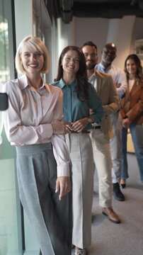 Diverse business team standing in line smiling