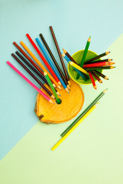A set of sharpened colored pencils on a colored background
