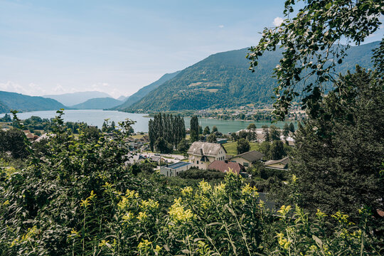 Ossiach, Austria - August 09, 2026: Scenic view of Ossiacher See with lush greenery, mountains, and traditional buildings in Carinthia during the Rindfleischfest celebration