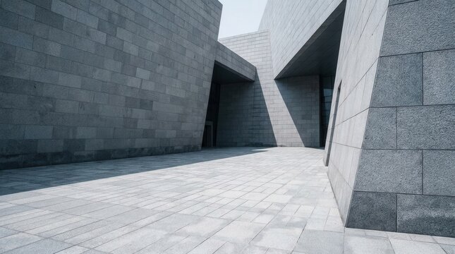 Contemporary building space with stone walls and paved ground area
