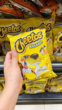 Salvador, Brazil - August 23, 2026: Packages of Cheetos snacks on a supermarket shelf in Brazil. Popular pepsico salty snack food products in Brazilian grocery retail. Cheetos snacks.