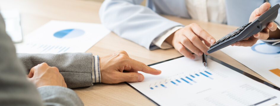 Business meeting, asian group brainstorm analysis on graph data of cost plan. financial consult planning investor asses and present to client, client and advisor review investment strategy in office.