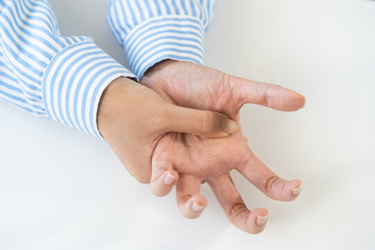 Health care and medical concept, rheumatism asian woman hand pain from cramp, trigger finger, wrist pain touching massaging, hand holding ache joint, arthritis inflammation.Chronic disease from injury