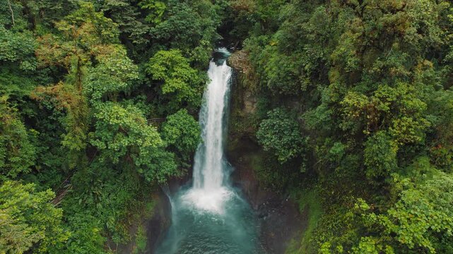 Rainforest waterfall hidden in lush greenery and natural pools in Costa Rica