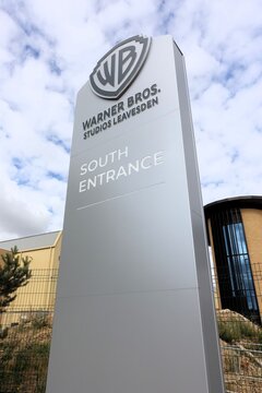 The sign at the south entrance of Warner Bros. Studios Leavesden marks an 80-hectare (200-acre) significant film and television studio complex situated in Hertfordshire, England.