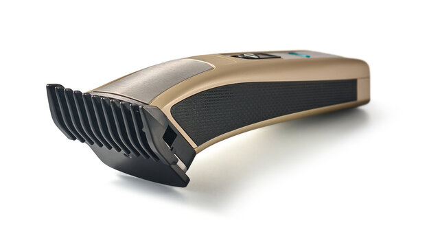 electric hair clipper isolated white background, gold and black cordless trimmer with plastic guard attachment side view with soft focus