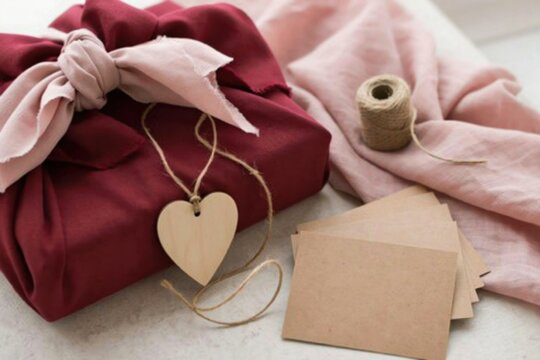 Gift wrapped in burgundy fabric with heart tag