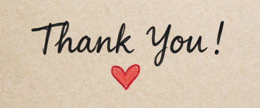 Thank you handwritten text on sand background