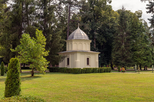 Small domed building in landscaped grounds of Curtea de Arges Monastery, Arges County, Romania