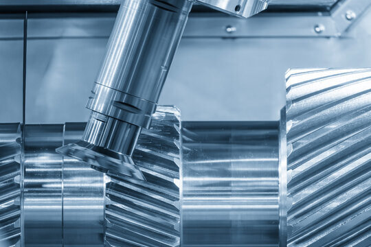 Metal gear parts manufacturing process on multi-tasking CNC machine in blue tone lighting