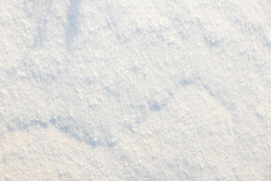 Fresh snow texture in sunlight as winter background