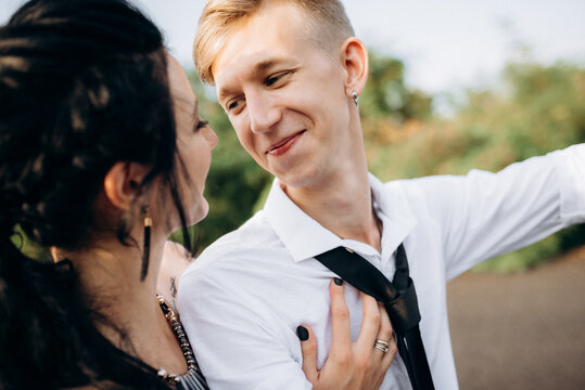A couple of newlywed freaks on a black custom bike