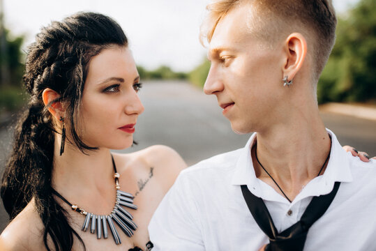 A couple of newlywed freaks on a black custom bike