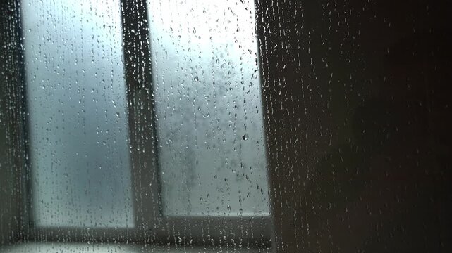 Raindrops on a window pane during a storm
