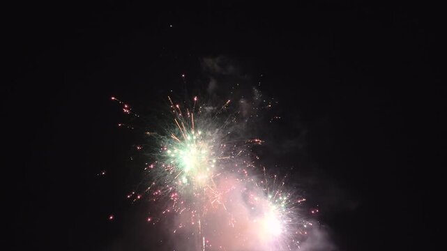 Assortment of fireworks exploding in night sky 4k
