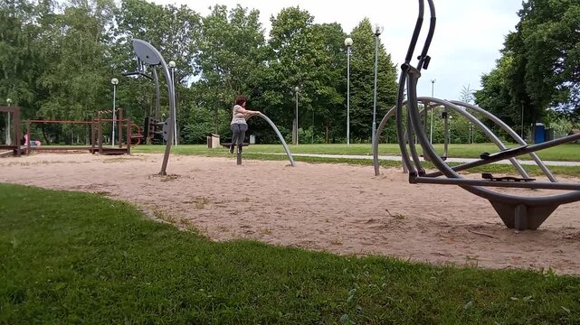 Woman Doing Outdoor Fitness Exercises in a Green Summer Park Video.


