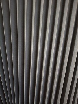 Dark grey pleated paper blind texture background, modern geometric folded pattern.