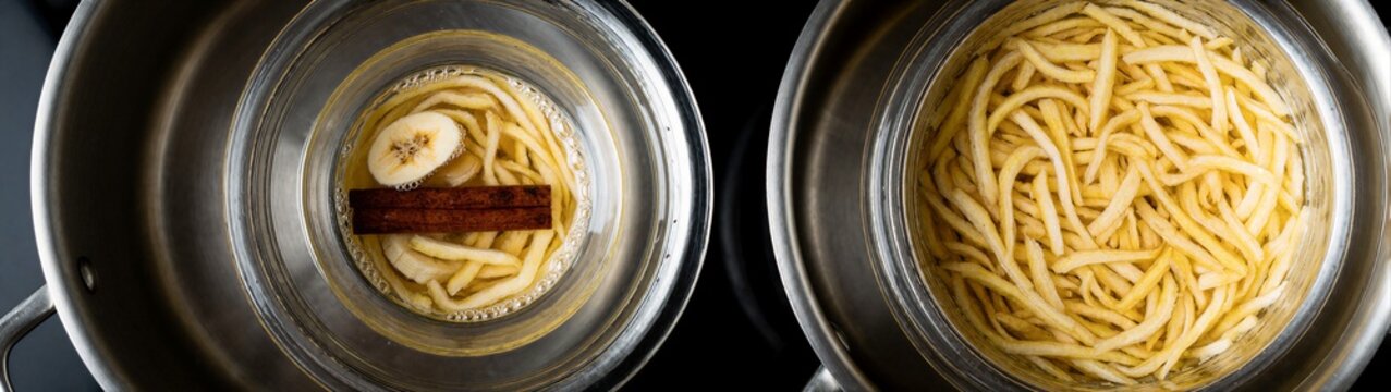 Banana slices soaking with cinnamon stick in metal bowls