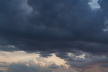 Obraz premium Dark storm clouds heavy sky background, dramatic thunderstorm cumulus cloudscape before rain, moody weather forecast backdrop, threatening hurricane or cyclone danger conceptual nature wallpaper.