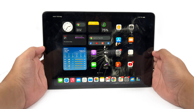 Kediri, East Java, Indonesia &ndash; August 21, 2026: Tablet Device with Home Screen Displayed in Hands and on White Surface