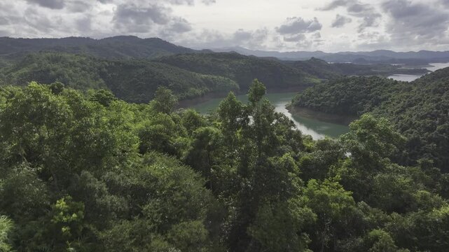 Aerial drone view of Ta Dung Lake surrounded by hundreds of green island hills and mountains in Ta Dung Commune, Lam Dong Province, Vietnam. View from QL 28. D Log mode