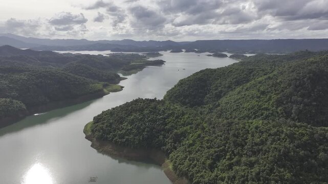 Aerial drone view of Ta Dung Lake surrounded by hundreds of green island hills and mountains in Ta Dung Commune, Lam Dong Province, Vietnam. View from QL 28. D Log mode