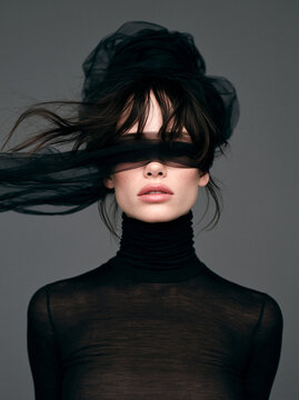 Studio portrait of a woman with closed eyes and flowing hair