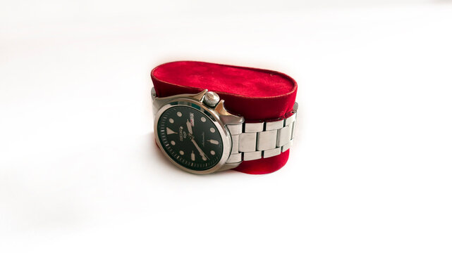 Kediri, East Java, Indonesia &ndash; August 21, 2026: Metallic Wristwatch with Dark Dial Displayed on Red Velvet Case