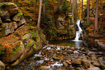 Fototapeta premium Waterfall. Autumn landscape of the Podgórna mountain waterfall in the forest of the Karkonosze National Park in Poland, Europe.